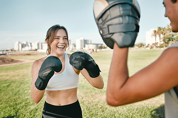 Image showing Fitness, personal trainer and boxing woman outdoor for exercise in nature park for health and wellness. Couple of friends happy about sports workout or fight with support, motivation and man coach