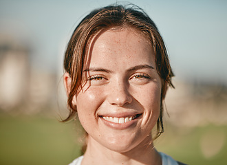 Image showing Portrait, happy and smile with a woman outdoor on a bokeh green background for carefree positivity. Face, wellness and zoom with an attractive young female standing outside on a summer day in nature