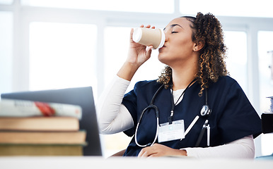 Image showing Medical student, technology and drinking coffee in hospital studying burnout, education books research or wellness learning. Tired, nurse or healthcare woman with drink, laptop or medicine internship