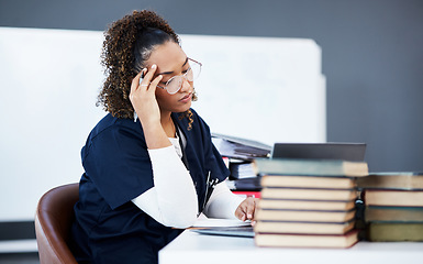 Image showing Medical student, tired or stress in hospital research, wellness books studying or education technology learning. Thinking woman, burnout or healthcare nurse anxiety in scholarship medicine internship