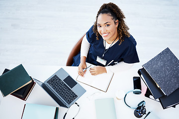 Image showing Top view, portrait or nurse on hospital laptop research, education woman studying or books learning for medical student. Above, smile or happy doctor on healthcare technology in medicine internship