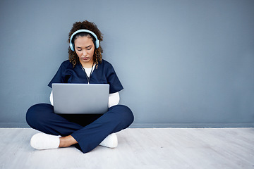 Image showing Woman, laptop and headphones of hospital music, podcast or radio in woman study research or mockup nurse learning. Doctor, technology and medical student listening to healthcare audio for focus help