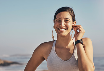 Image showing Woman, fitness and portrait while listening to music at beach for exercise, training and workout. Happy model person face in nature with earphones for podcast, audio and motivation outdoor in nature