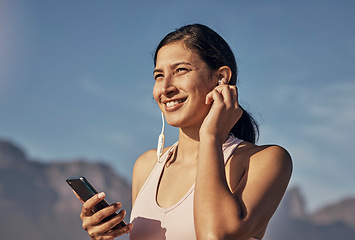 Image showing Woman, fitness and phone for music in nature outdoor for exercise, training and workout. Happy model person listening to earphones for podcast, audio and motivation for health and wellness blue sky