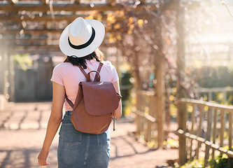 Image showing Back, woman and travel for summer, outdoor and walking for sightseeing, break and vacation. Female tourist, student and lady with backpack, explore landmarks or enjoy holiday for adventure or journey