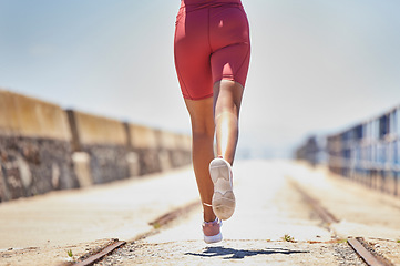 Image showing Legs, running and fitness with runner outdoor, black woman athlete with cardio, speed and sneakers with run on bridge. Runner, active and sports with workout, exercise back view and mockup space