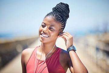 Image showing Fitness, black woman and happy runner with earphones for training exercise outdoor. Face, smile and female athlete listening to music for sports motivation, healthy goals and audio of running workout