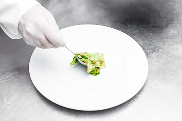 Image showing Chef putting iceberg lettuce