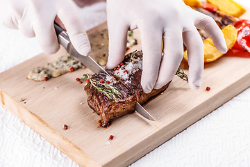 Image showing Chef cutting beef steak