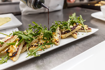 Image showing Chef decorating appetizer dish