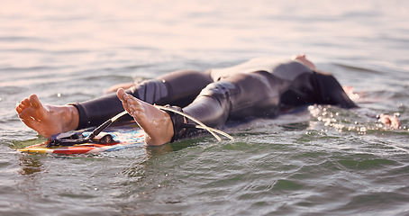 Image showing Surfing, ocean and man float on water feeling relax, calm and freedom in nature. Sea, exercise and fitness of a young male on a surfboard with rest in tropical waters ready for surf and sports