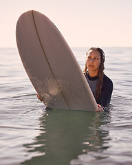 Image showing Surfer, woman and swimming in water, sea and ocean for summer adventure, freedom and vacation. Female surfing on board in waves, beach and relax for tropical holiday, nature travel and island sports