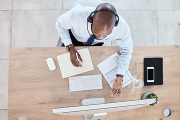 Image showing Top view, black man or consultant in call center, customer service or talking with headset. African American male employee, agent or worker with computer, headphones or tech support to help in office