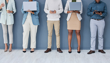 Image showing Business people, waiting or technology in job interview row, recruitment line or hr wall queue. Diversity, men or women legs in human resources, hiring or onboarding office on phone, laptop or tablet