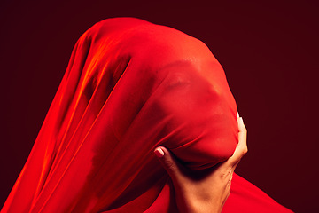 Image showing Model, red fabric and hidden face for fashion, aesthetic and beauty by dark studio background. Gen z woman, cloth or silk veil for creativity, design and art with retro, vintage or creative clothes