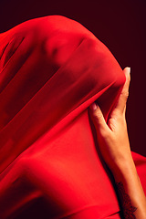 Image showing Woman, red fabric and hide face for fashion, aesthetic and sensual with dark studio background. Gen z model, cloth or silk veil for creativity, vision and art with retro, vintage or creative clothes