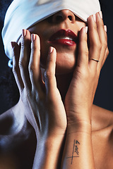 Image showing Hands, blindfolded and woman in studio for creative, fashion and artistic aesthetic on black background. Model, blind and covered vintage beauty by girl model with luxury, fabric or elegant blindfold