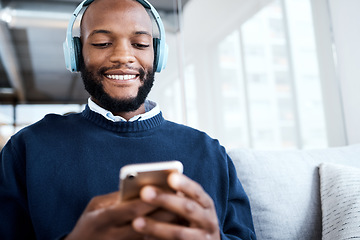 Image showing Black man with smartphone, headphones and face, music and smile, scroll social media and audio streaming. Online, listening to radio or podcast with happiness and relax with texting or email