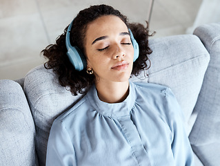 Image showing Headphones, woman and face for listening to music for calm, peace and mental health on home couch. Young person on living room sofa listen to podcast, audio or motivation to relax or meditation above