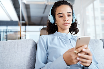 Image showing Phone, music headphones and business woman on sofa in office streaming audio. Cellphone, relax technology and female employee on couch listening to podcast, radio or sound with mobile smartphone.