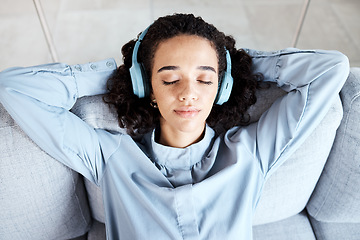 Image showing Woman face, relax and headphones for listening to music for calm, peace and mindfulness. Young person on living room sofa listen to podcast, audio or motivation for meditation above home couch