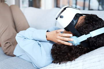 Image showing Virtual reality, metaverse and gaming with a black woman on a sofa in the living room of her home. AI, 3D and VR with a young female gamer using a headset to access cyberspace for a video game