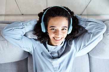 Image showing Top view, portrait and woman on sofa, headphones and relax for break, peace and smile with joy. Female, lady and headset music, streaming and listen to podcast for happiness, cheerful and peaceful