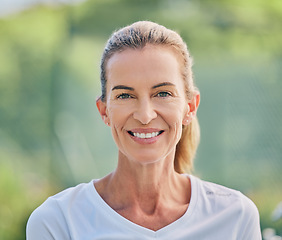 Image showing Happy, sports and portrait of a woman in tennis for training, fitness and cardio competition on a court in France. Motivation, exercise and face of a mature sport player standing for a match