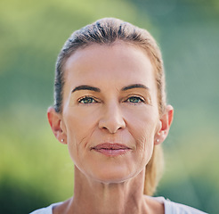 Image showing Beauty, portrait and mature woman in nature for health, wellness or fresh air in summer. Beautiful, headshot and senior female model from Australia standing in a green garden, park or field.