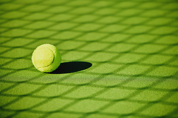 Image showing Tennis ball, court shadow and green texture of grass turf game with no people. Sports, empty sport training ground and lawn object zoom of shadow for workout, exercise and fitness for a match outdoor