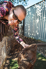 Image showing Young woman caress the beaver