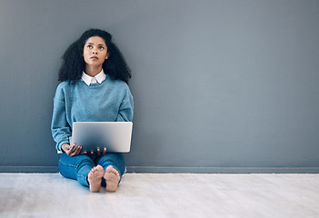 Image showing Laptop, thinking and idea with black woman on floor for social media, news and research on wall mockup . Designer, online shopping and technology with girl for communication, internet and marketing