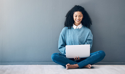 Image showing Laptop, happy and research with black woman on floor for social media, news and designer on wall mockup. Website, online shopping and technology with girl for communication, internet and advertising