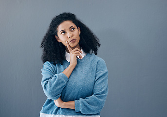 Image showing Thinking, ponder and woman in a studio contemplating a question or plan in her head. Wondering, pensive and female model from Mexico brainstorming while isolated by gray background with mockup space.