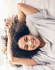 Image showing Black woman, wake up and top view portrait in bedroom after sleeping or resting. Peace, bed relax and comfort of happy female awake after sleep on comfortable pillow and blankets for healthy rest.