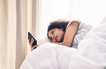 Image showing Bed, black woman and typing on phone in home bedroom for social media, texting or internet browsing in the morning. Technology, relax and female with mobile smartphone for web scrolling or networking