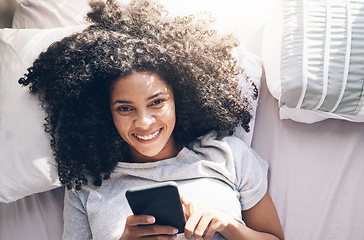 Image showing Black woman, phone and top view in home bedroom for social media, texting or internet browsing in the morning. Portrait, bed relax and female with mobile smartphone for web scrolling or networking.