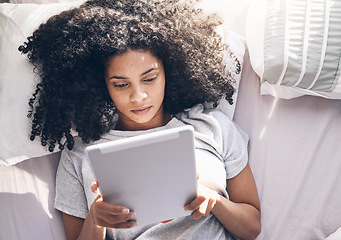 Image showing Black woman, tablet and top view in bed in bedroom for social media, texting or internet browsing in the morning. Technology, relax and female on digital touchscreen for web scrolling or networking.