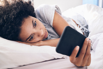 Image showing Phone, social media and a black woman lying in bed in the morning after waking up on the weekend. Mobile, communication and relax with an attractive young female resting in her bedroom in a house