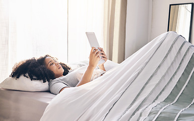 Image showing Relax, black woman and tablet in bed in bedroom for social media, texting or internet browsing in the morning. Technology, home and female with digital touchscreen for web scrolling after waking up.