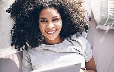 Image showing Black woman, tablet and top view in bed in bedroom for social media, texting or internet browsing in the morning. Portrait, relax and female on digital touchscreen for web scrolling or networking.