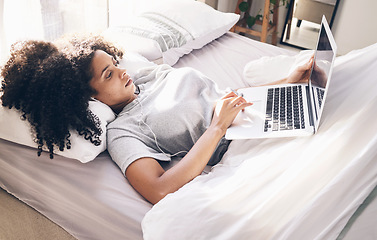 Image showing Music earphones, woman and laptop in bed in bedroom for social media or internet browsing in the morning. Technology, relax or black female with computer for streaming podcast, audio or radio in home