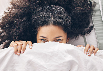 Image showing Above bed, portrait and black woman in the morning after sleep rest and relaxing at home with blanket. Eyes, house and wake up happiness of a young person hiding face under the bedroom covers