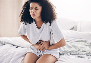 Image showing Abdomen pain, period and black woman in bed with abdominal cramps, menstruation and stomach ache. Health, medical emergency and girl with digestion problem, pms crisis and endometriosis in bedroom