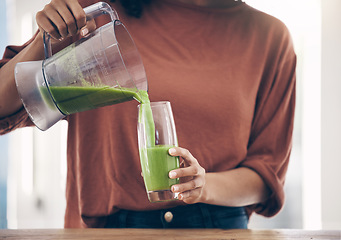 Image showing Green, smoothie and hands of woman with a drink in the kitchen for breakfast, detox and diet. Hand, nutritionist and lady with fresh, weight loss and healthy, raw and vegan lifestyle, shake and juice