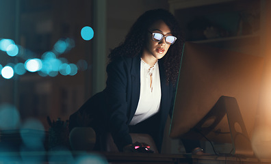 Image showing Business, night and black woman on computer at desk for project, strategy report and reading email. Corporate manager, dark office and female standing done working on schedule, planning and research
