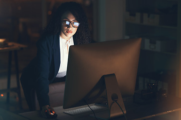 Image showing Business, night and black woman done on computer for project, strategy report and reading email. Corporate manager, dark office and female standing at desk working on schedule, planning and research