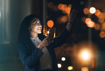 Image showing Phone, night and business woman in the office with bokeh lights to work late on a project with a deadline. Technology, dark and professional African female employee working overtime in the workplace.