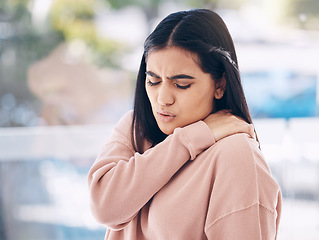 Image showing Neck, pain and mockup with an indian woman holding her shoulder on a glass background while suffering from cramp. Medical, anatomy or muscle and an attractive young female struggling with an injury