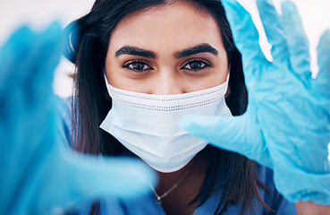 Image showing Doctor, gloves and face in frame with face mask for covid exam or surgery focus. Closeup portrait of woman medical expert, surgeon or nurse with latex hands ready in checkup examination